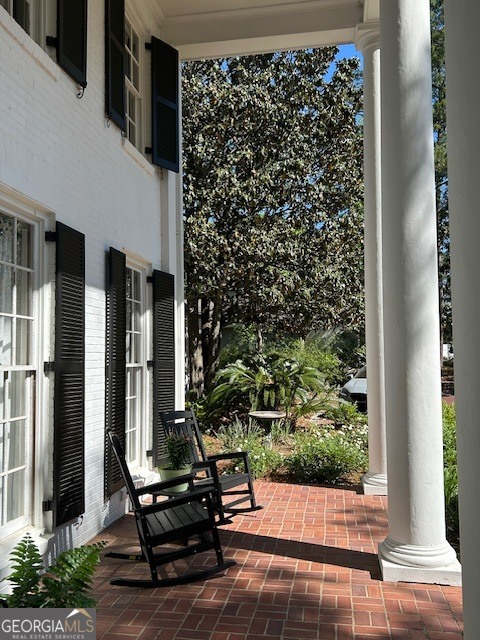 1156 South Main Street Moultrie, GA 31768 - Photo 4 of 56 a view of a porch with chairs and potted plants
