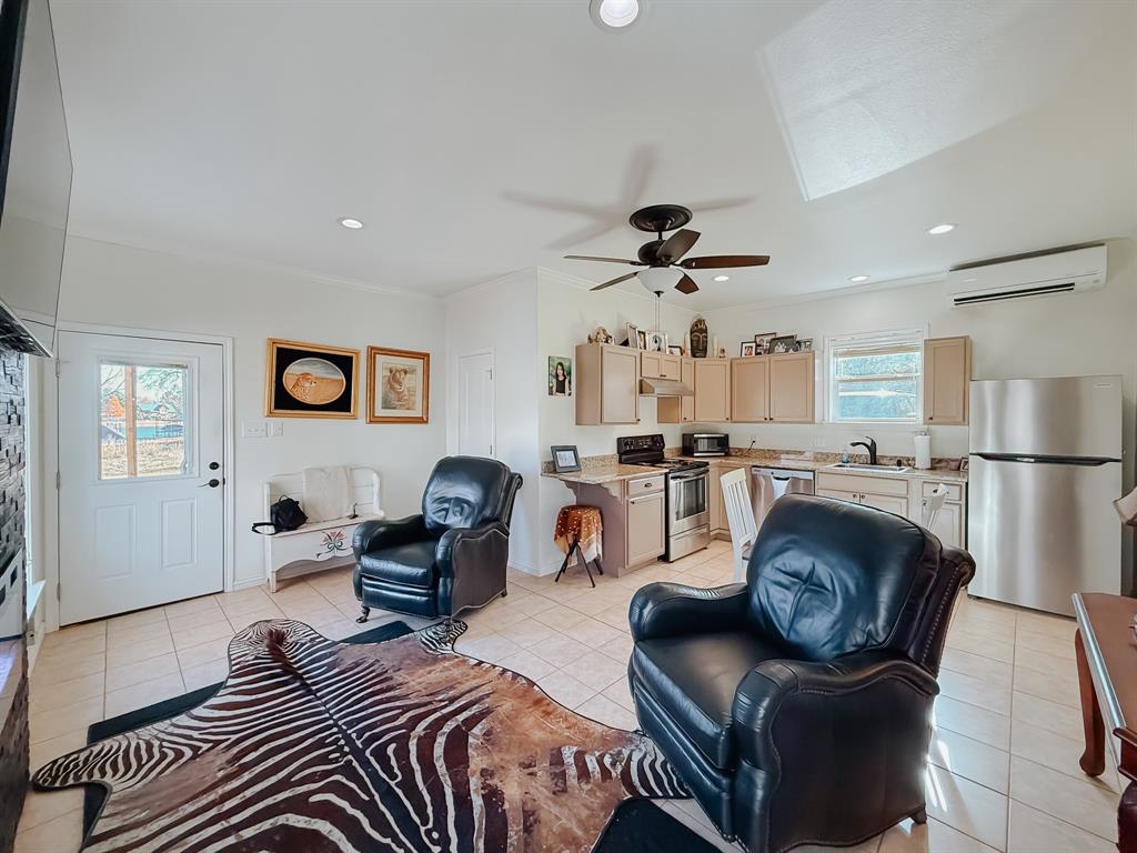 128 Meandering Way Mabank, TX 75156 - Photo 13 of 38 a living room with furniture and a chandelier
