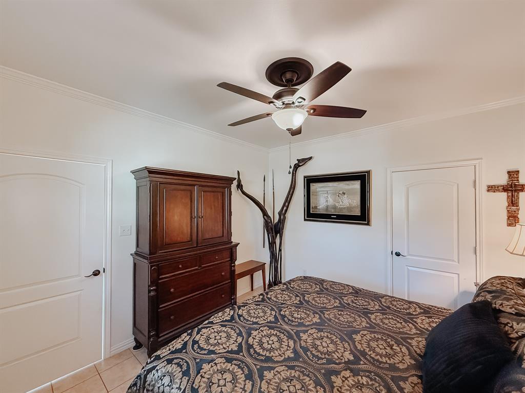 128 Meandering Way Mabank, TX 75156 - Photo 16 of 38 a bedroom with a bed and a chandelier