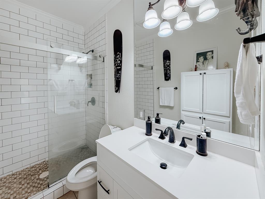 128 Meandering Way Mabank, TX 75156 - Photo 17 of 38 a bathroom with a sink a toilet and shower