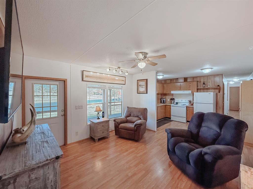 128 Meandering Way Mabank, TX 75156 - Photo 22 of 38 a living room with furniture and a flat screen tv
