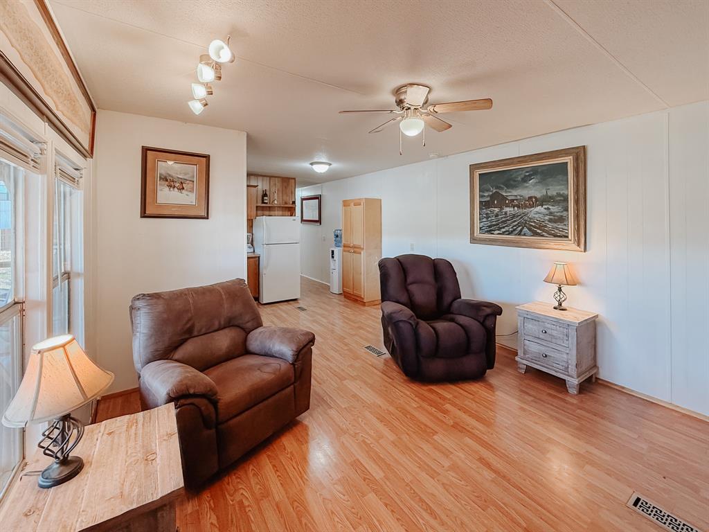 128 Meandering Way Mabank, TX 75156 - Photo 23 of 38 a living room with furniture and a wooden floor