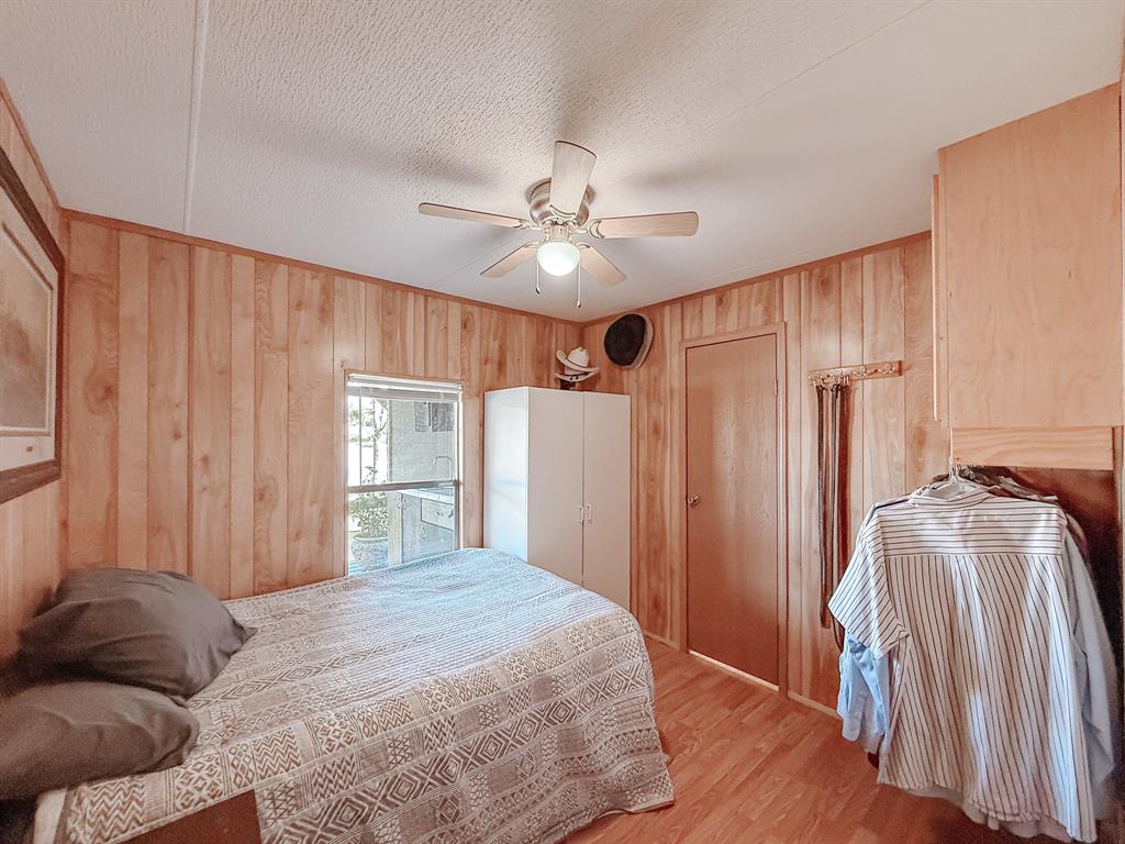 128 Meandering Way Mabank, TX 75156 - Photo 27 of 38 a bedroom with a bed and a chandelier