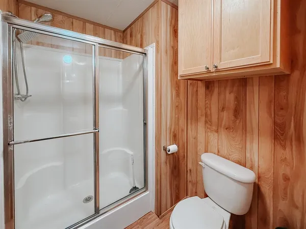 a bathroom with a sink a toilet and shower curtain