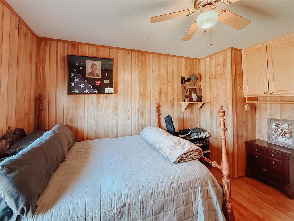 128 Meandering Way Mabank, TX 75156 - Photo 31 of 38 a bedroom with a bed and a chandelier