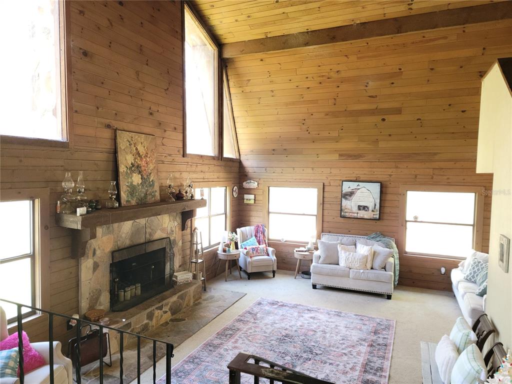 1600 Southwest 42nd Street Ocala, FL 34471 - Photo 2 of 39 a living room with furniture a fireplace and a window