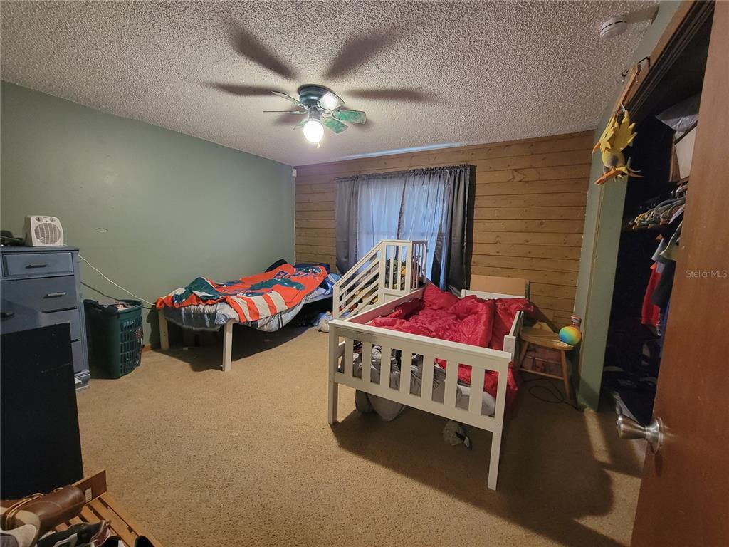 1600 Southwest 42nd Street Ocala, FL 34471 - Photo 21 of 39 a bedroom with two beds and a chandelier