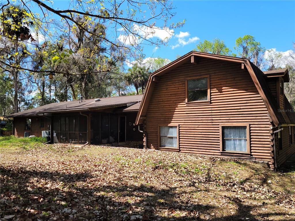 1600 Southwest 42nd Street Ocala, FL 34471 - Photo 26 of 39 a backyard of a house with large trees and wooden fence