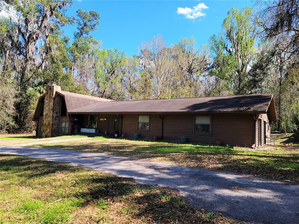 1600 Southwest 42nd Street Ocala, FL 34471 - Photo 39 of 39 a front view of a house with a yard and trees
