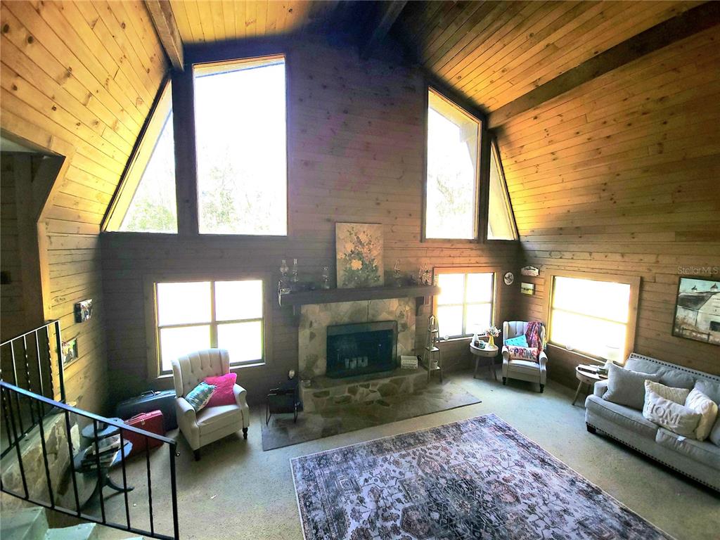 1600 Southwest 42nd Street Ocala, FL 34471 - Photo 4 of 39 a living room with furniture a fireplace and windows