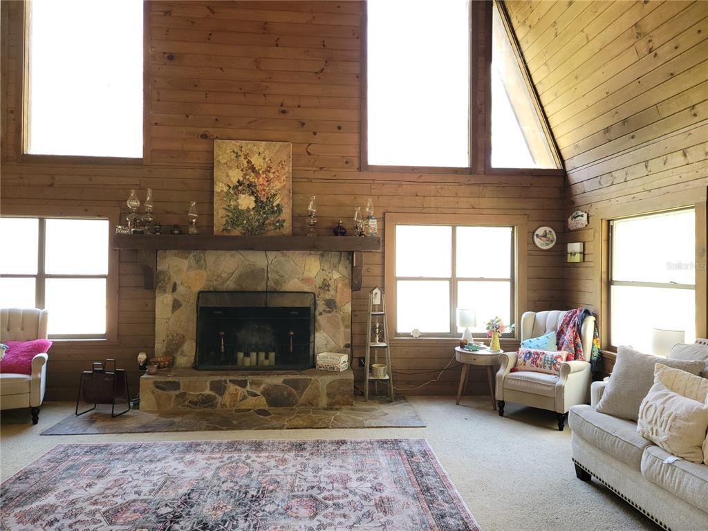 1600 Southwest 42nd Street Ocala, FL 34471 - Photo 5 of 39 a living room with furniture a window and a fireplace