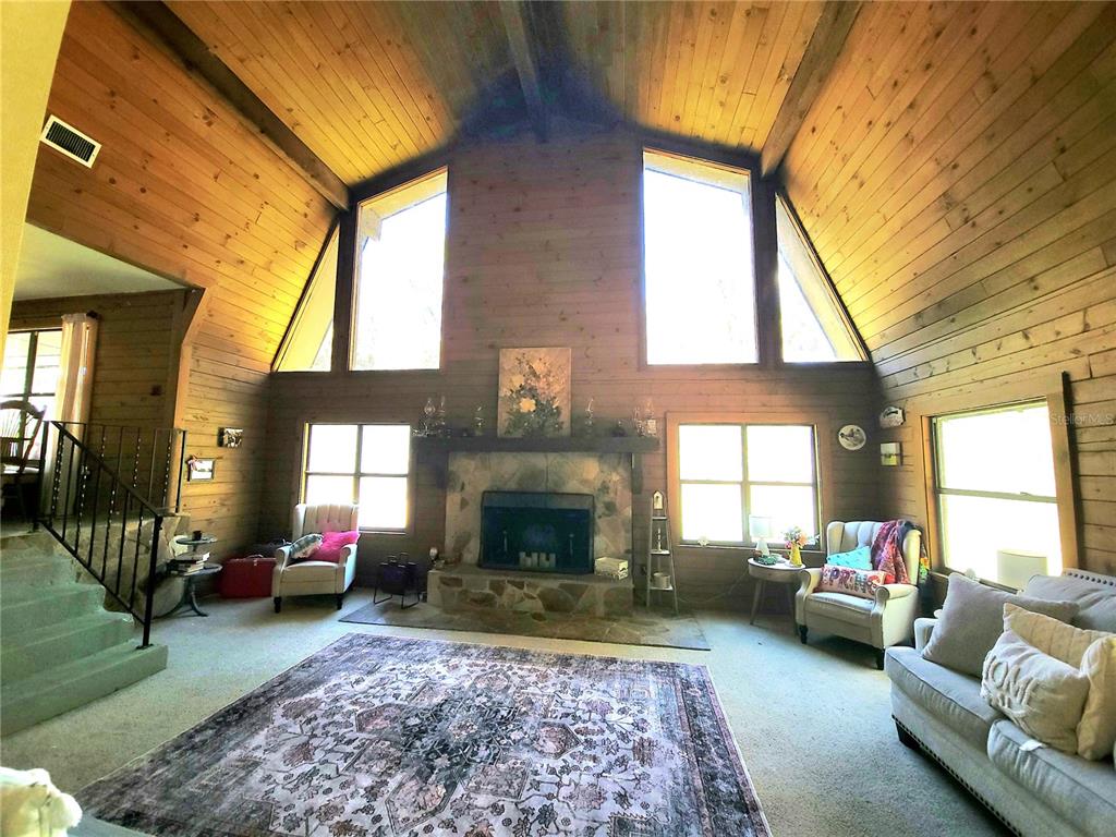 1600 Southwest 42nd Street Ocala, FL 34471 - Photo 7 of 39 a living room with furniture and a fireplace