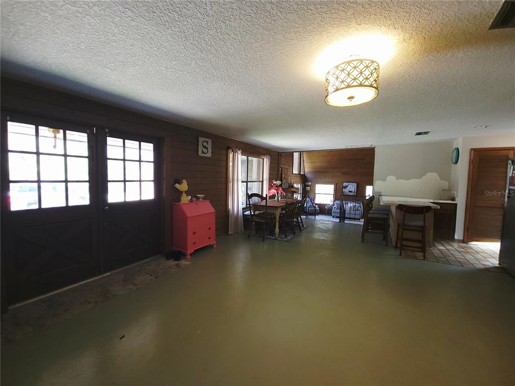 1600 Southwest 42nd Street Ocala, FL 34471 - Photo 10 of 39 a living room with furniture and a chandelier