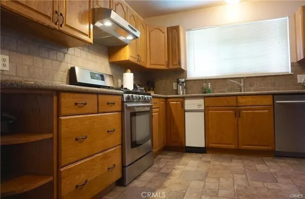 a kitchen with cabinets and appliances
