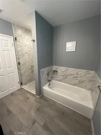 a spacious bathroom with bathtub and shower