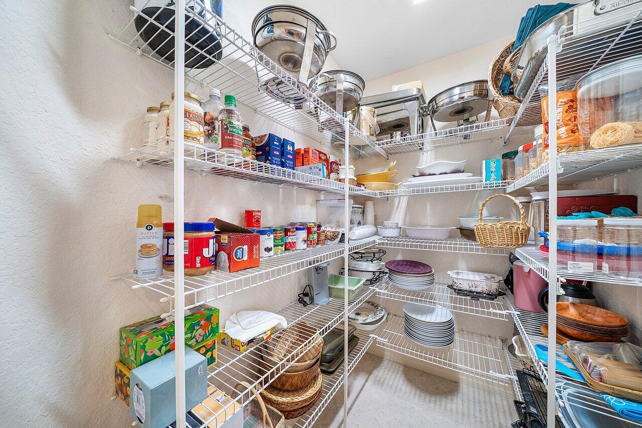 7094 Vía Mediterrania Boca Raton, FL 33433 - Photo 14 of 46 a store room with lots of different colored cloths