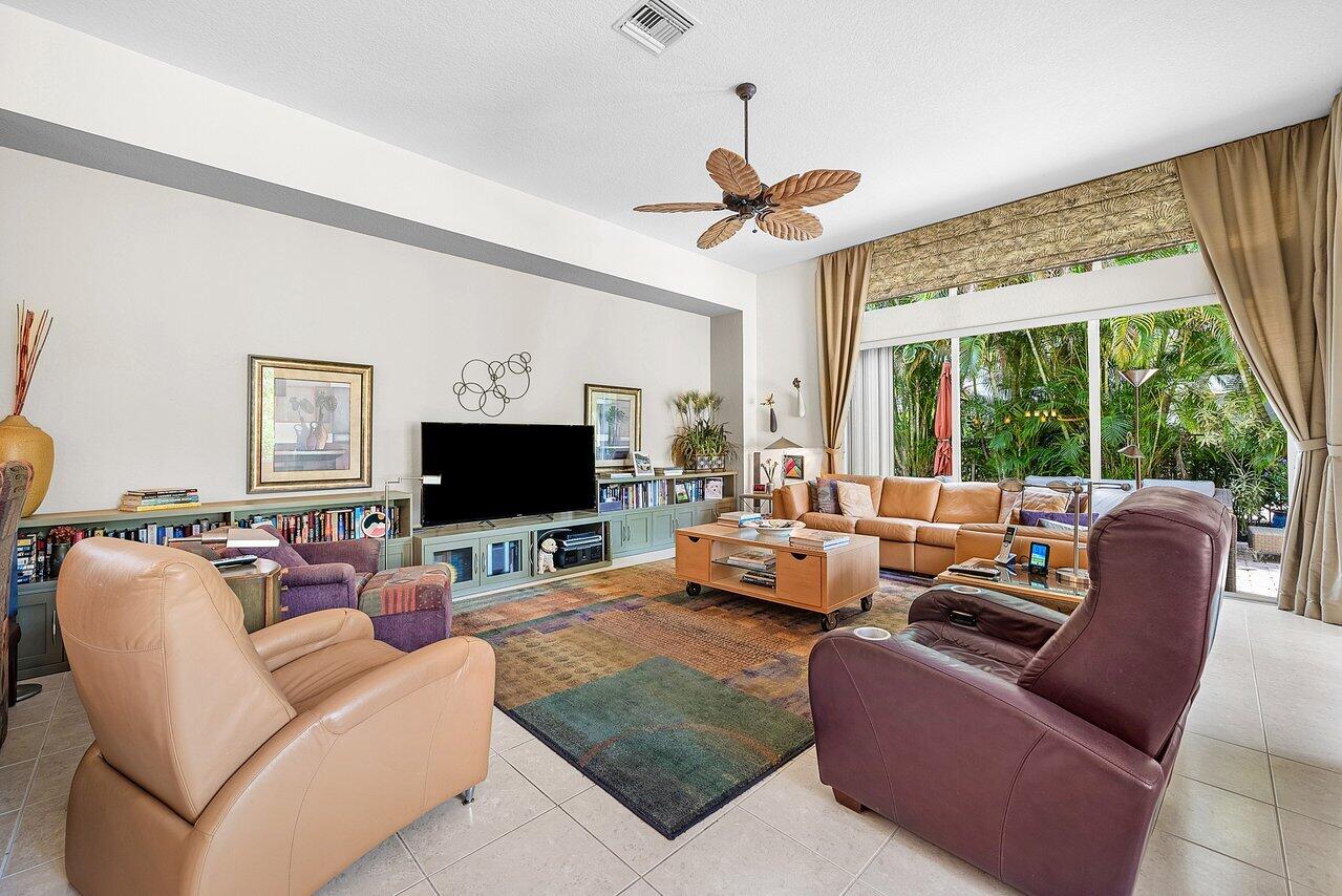 7094 Vía Mediterrania Boca Raton, FL 33433 - Photo 16 of 46 a living room with furniture and a flat screen tv