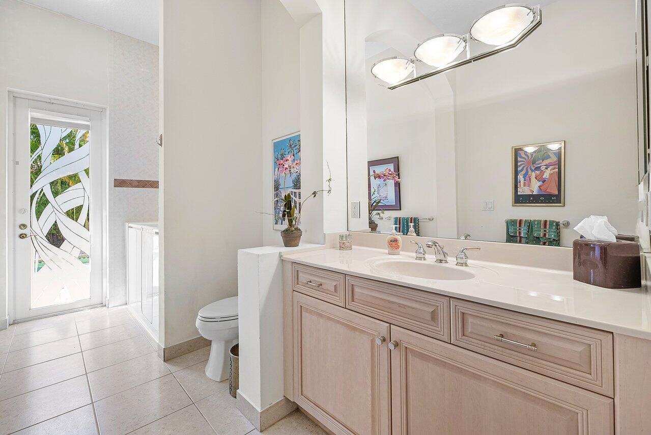 7094 Vía Mediterrania Boca Raton, FL 33433 - Photo 21 of 46 a spacious bathroom with a granite countertop sink mirror vanity and toilet