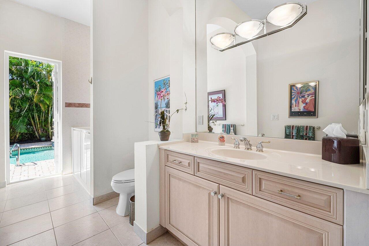 7094 Vía Mediterrania Boca Raton, FL 33433 - Photo 22 of 46 a spacious bathroom with a granite countertop sink a toilet and a mirror