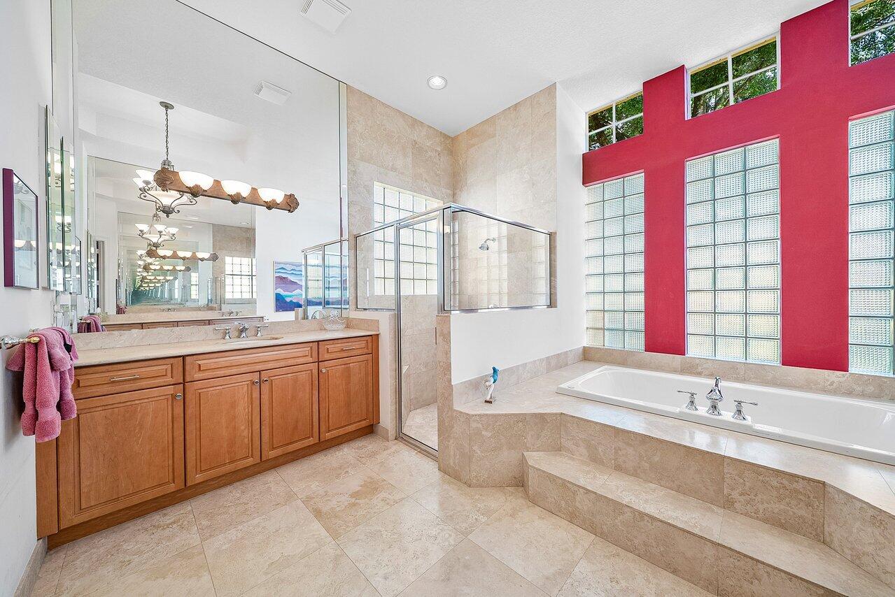7094 Vía Mediterrania Boca Raton, FL 33433 - Photo 28 of 46 a spacious bathroom with a granite countertop tub sink and mirror