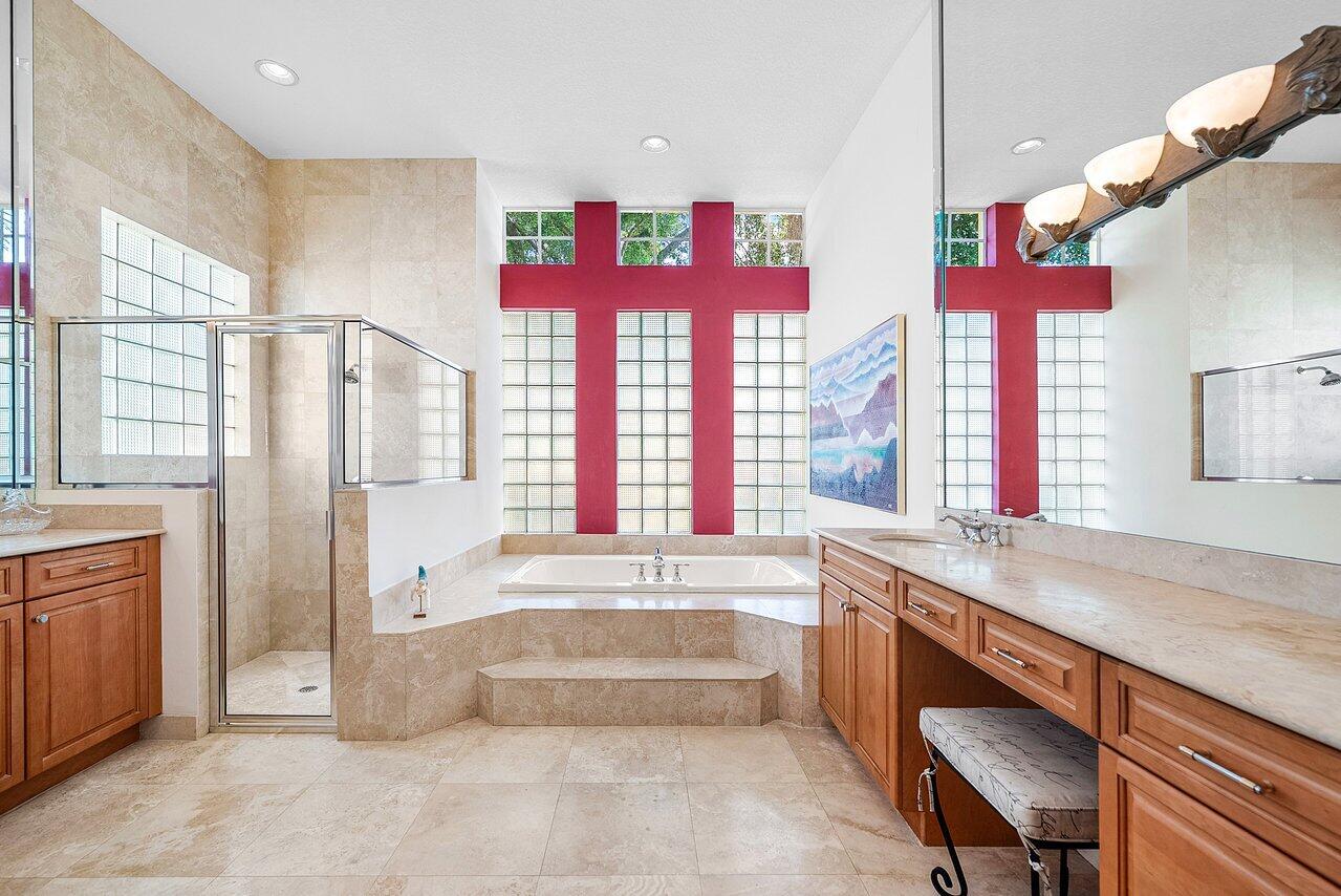 7094 Vía Mediterrania Boca Raton, FL 33433 - Photo 29 of 46 a spacious bathroom with a tub a sink and a large window