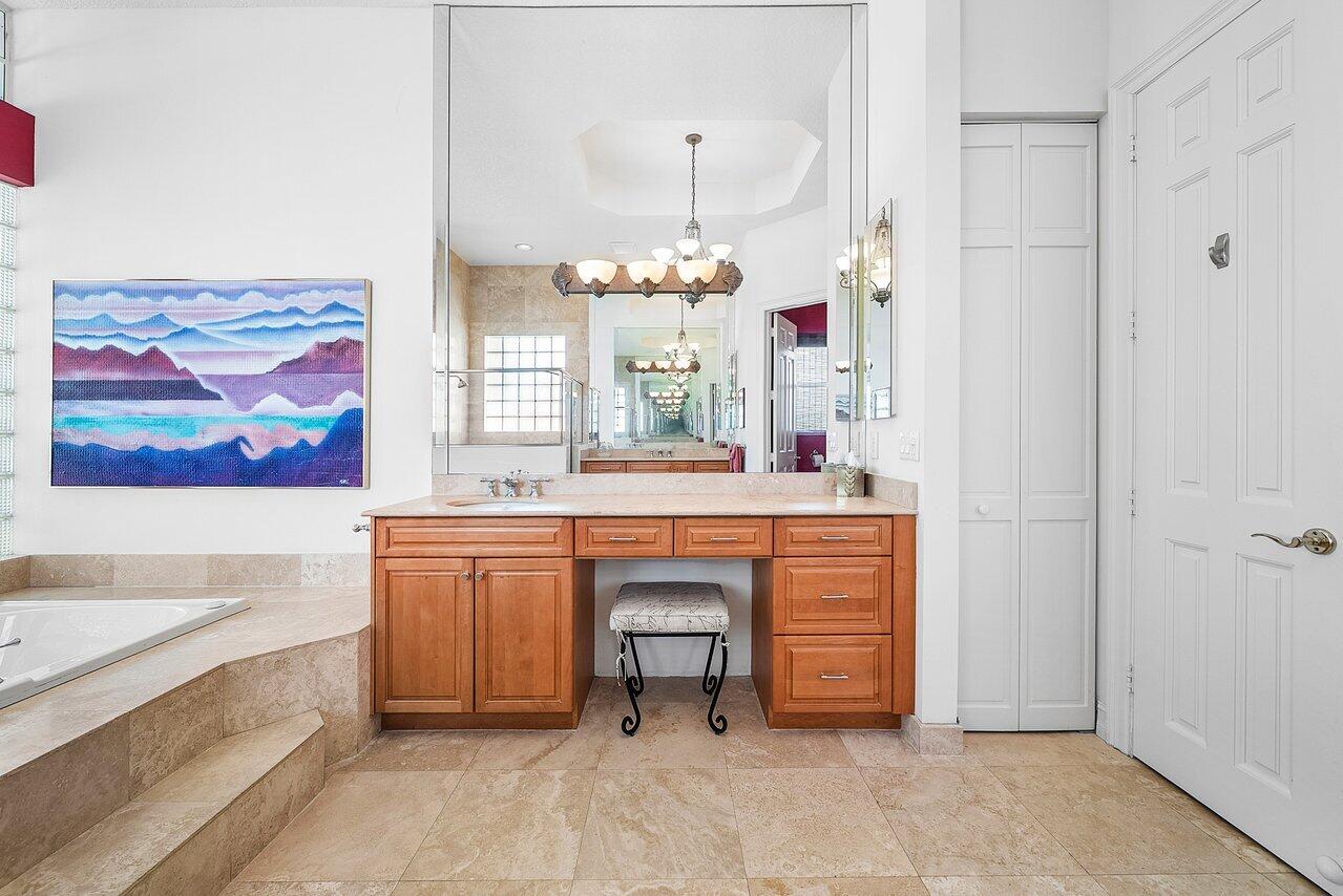 7094 Vía Mediterrania Boca Raton, FL 33433 - Photo 30 of 46 a spacious bathroom with a double vanity sink a mirror and a bathtub