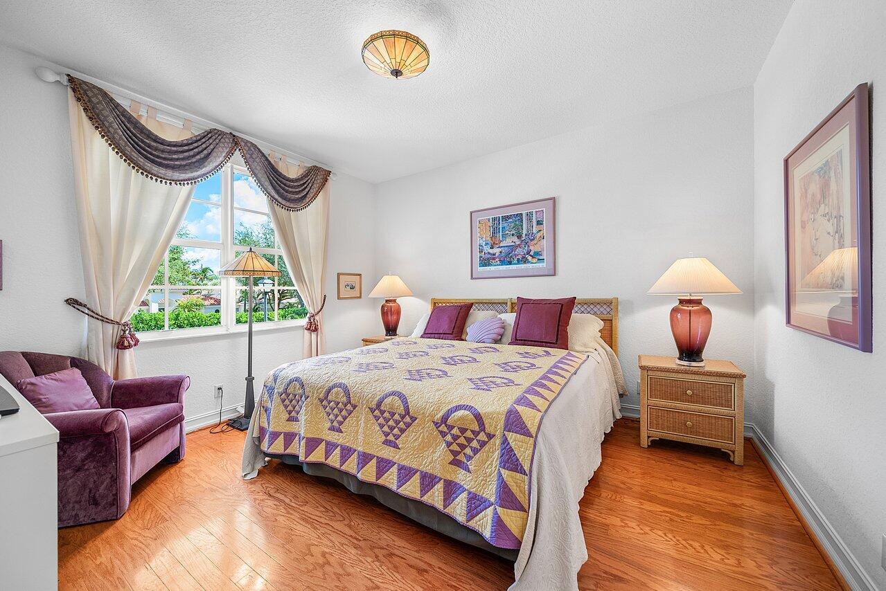 7094 Vía Mediterrania Boca Raton, FL 33433 - Photo 36 of 46 a bedroom with a bed chair and a large window