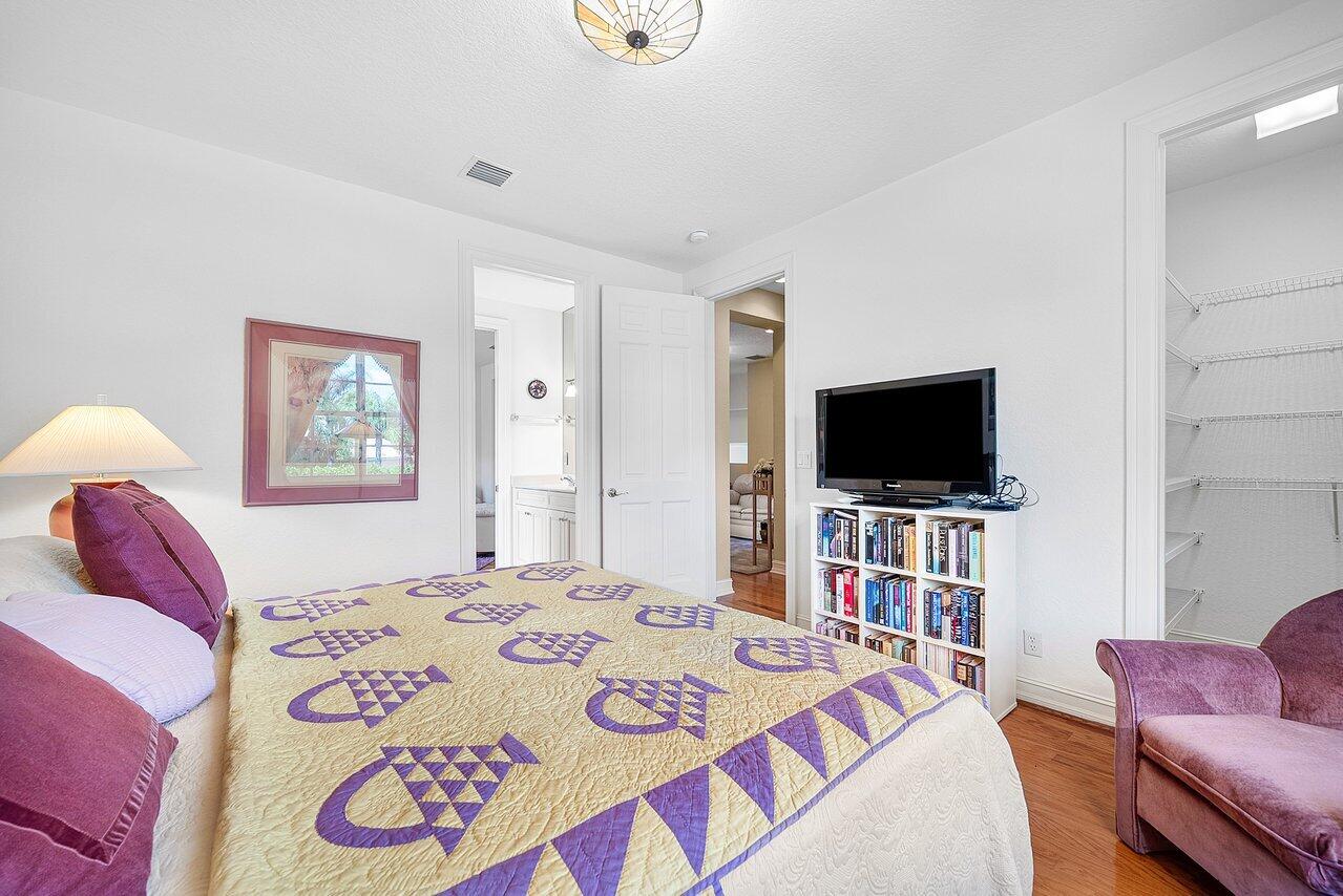 7094 Vía Mediterrania Boca Raton, FL 33433 - Photo 37 of 46 a bedroom with a bed and a flat screen tv