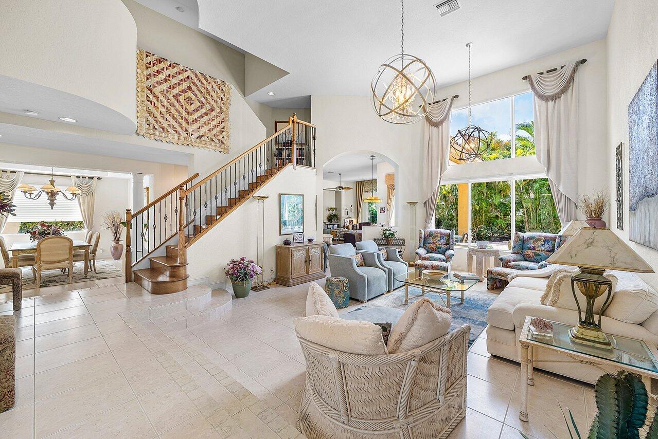 7094 Vía Mediterrania Boca Raton, FL 33433 - Photo 5 of 46 a living room with couches chandelier and a large window