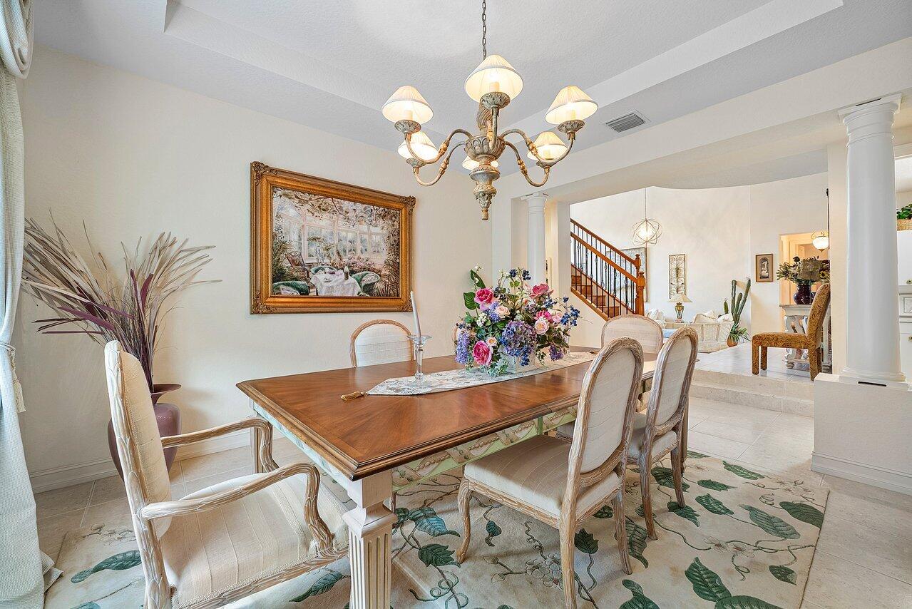 7094 Vía Mediterrania Boca Raton, FL 33433 - Photo 9 of 46 a view of a dining room with furniture and chandelier