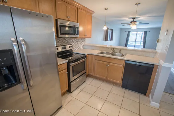 a kitchen with stainless steel appliances a stove a sink and a refrigerator