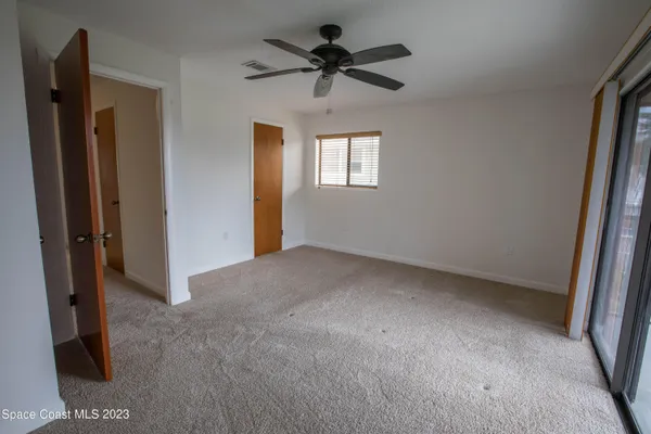 a view of a livingroom with a ceiling fan and window