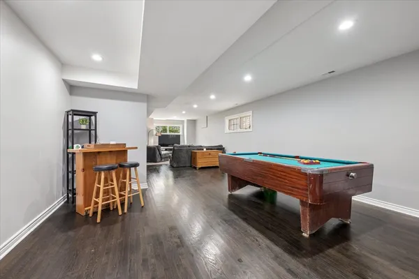 a room with lounge chair and wooden floor