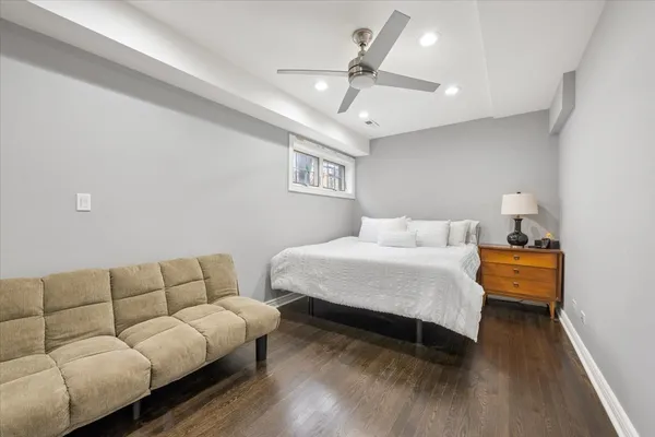 a bedroom with furniture and a wooden floor