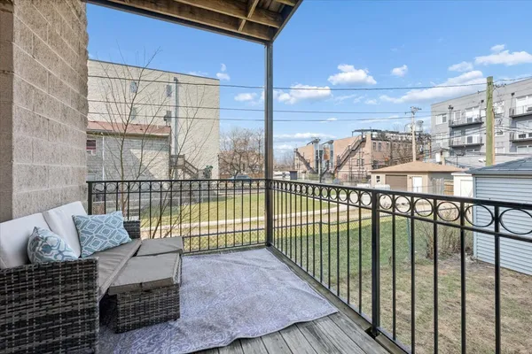 a view of a balcony with floor to ceiling window next to a building