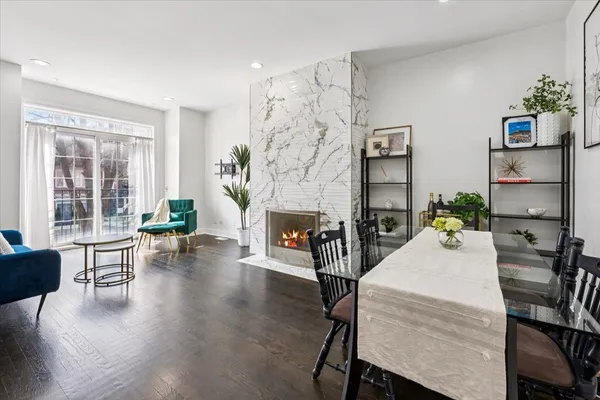 a living room with furniture a fireplace and a potted plant