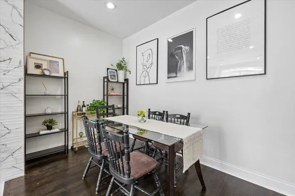 a view of a dining room with furniture and wooden floor