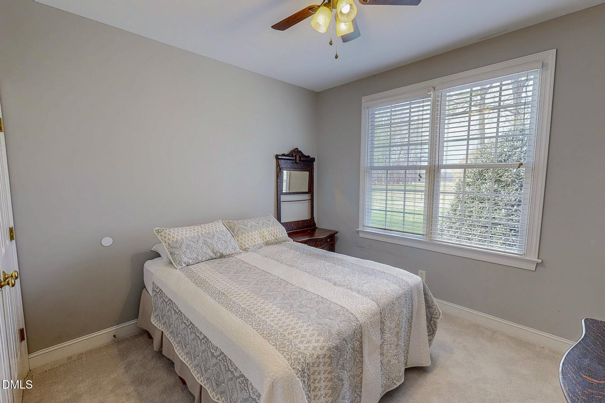 353 Fletcher Ridge Road Timberlake, NC 27583 - Photo 36 of 44 a bedroom with a large bed and a chandelier