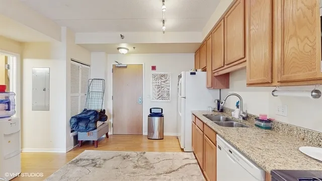 a kitchen with stainless steel appliances granite countertop a sink refrigerator and cabinets