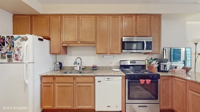 a kitchen with stainless steel appliances granite countertop a refrigerator sink and cabinets