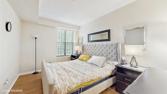 a bedroom with a bed and a night stand