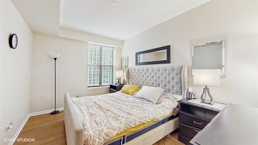 1250 South Indiana Avenue, Unit 1002 Chicago, IL 60605 - Photo 15 of 25 a bedroom with a bed and a night stand