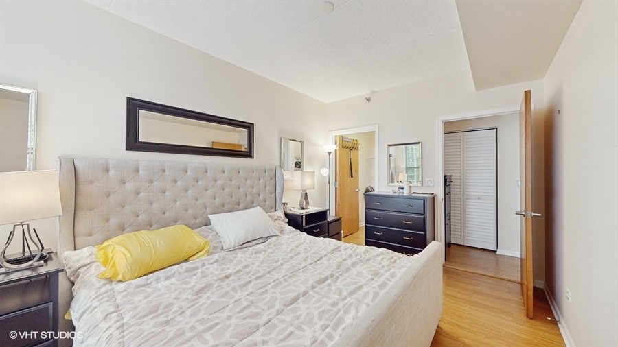 1250 South Indiana Avenue, Unit 1002 Chicago, IL 60605 - Photo 16 of 25 a bedroom with a bed and a dresser