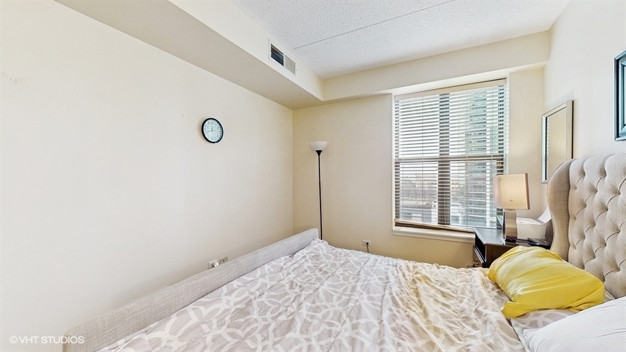 1250 South Indiana Avenue, Unit 1002 Chicago, IL 60605 - Photo 17 of 25 a bedroom with a bed and a window