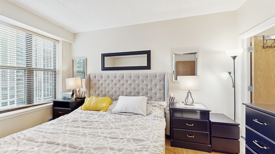 1250 South Indiana Avenue, Unit 1002 Chicago, IL 60605 - Photo 18 of 25 a bedroom with a bed and a dresser