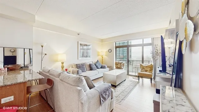 a living room with furniture large windows and a flat screen tv