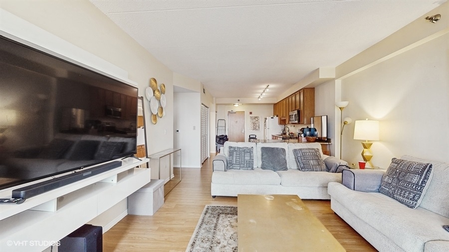 1250 South Indiana Avenue, Unit 1002 Chicago, IL 60605 - Photo 6 of 25 a living room with furniture and a flat screen tv