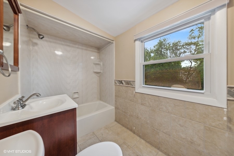 238 West Hickory Road Lombard, IL 60148 - Photo 11 of 17 a bathroom with a sink mirror toilet and bathtub