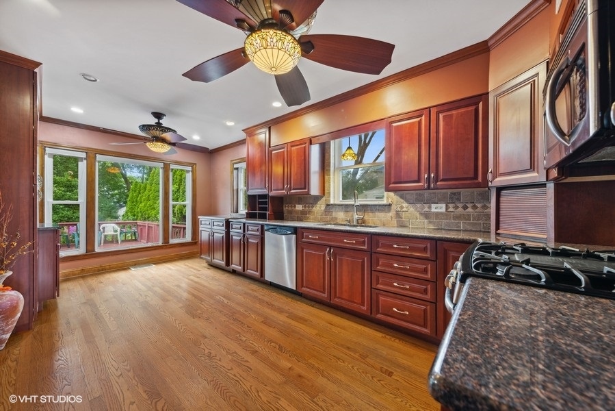 238 West Hickory Road Lombard, IL 60148 - Photo 2 of 17 a kitchen with stainless steel appliances granite countertop a stove a sink and a microwave