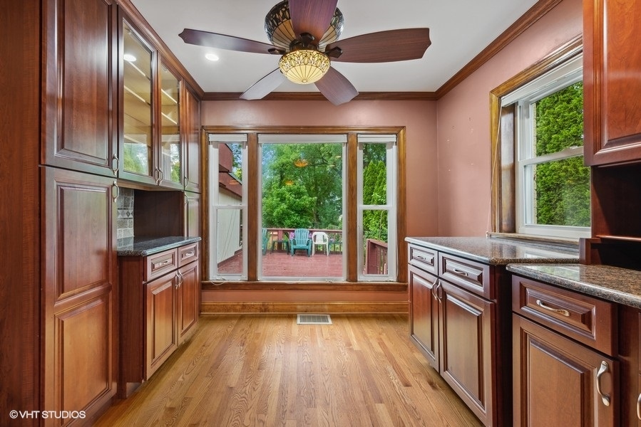 238 West Hickory Road Lombard, IL 60148 - Photo 3 of 17 a kitchen with kitchen island granite countertop a stove top oven a sink and wooden floors